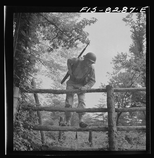 Untitled photo, possibly related to: Fort Belvoir, Virginia. Sergeant George Camblair getting rigorous physical training on the obstacle course