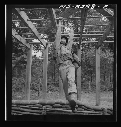 Fort Belvoir, Virginia. Sergeant George Camblair getting a rigorous physical training on the obstacle course
