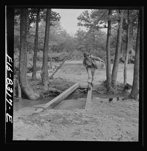 Fort Belvoir, Virginia. Sergeant George Camblair getting rigorous physical training on the obstacle course