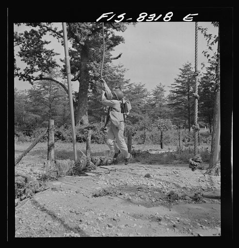 Untitled photo, possibly related to: Fort Belvoir, Virginia. Sergeant George Camblair getting rigorous physical training on the obstacle course