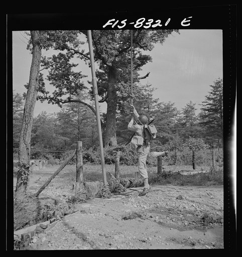 Untitled photo, possibly related to: Fort Belvoir, Virginia. Sergeant George Camblair getting rigorous physical training on the obstacle course
