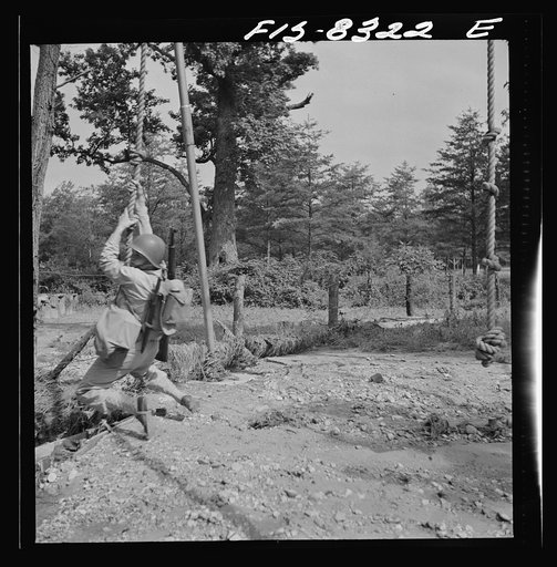 Untitled photo, possibly related to: Fort Belvoir, Virginia. Sergeant George Camblair getting rigorous physical training on the obstacle course
