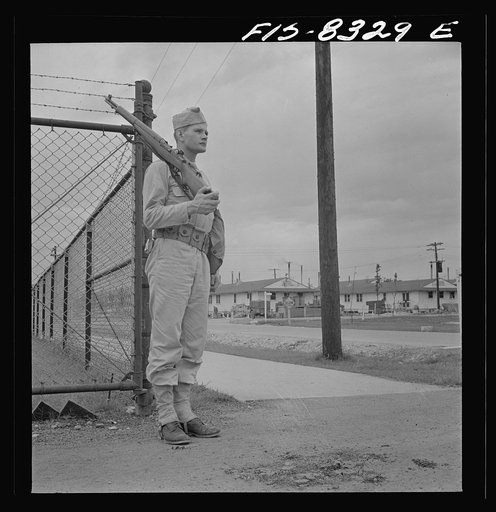 Untitled photo, possibly related to: Fort Belvoir, Virginia. Sergeant George Camblair on sentry duty at camp