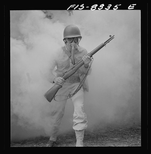 Untitled photo, possibly related to: Fort Belvoir, Virginia. Sergeant George Camblair learning how to use a gas mask in a practice smokescreen
