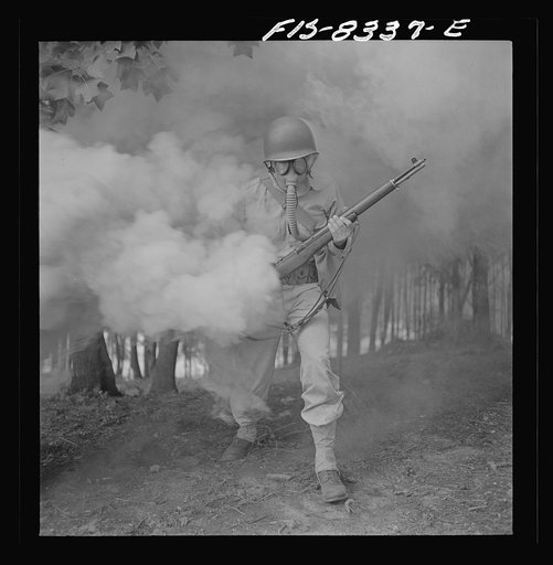 Fort Belvoir, Virginia. Sergeant George Camblair learning how to use a gas mask in a practice smokescreen