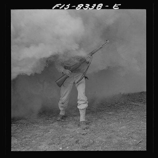Untitled photo, possibly related to: Fort Belvoir, Virginia. Sergeant George Camblair learning to use a gas mask in a practice smokescreen