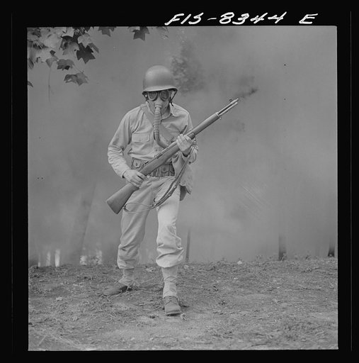 Untitled photo, possibly related to: Fort Belvoir, Virginia. Sergeant George Camblair learning how to use a gas mask in a practice smokescreen