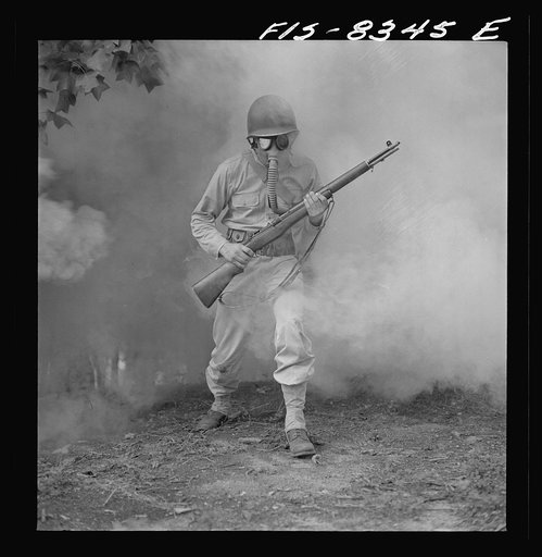 Untitled photo, possibly related to: Fort Belvoir, Virginia. Sergeant George Camblair learning how to use a gas mask in a practice smokescreen