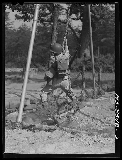 Fort Belvoir, Virginia. Sergeant George Camblair getting rigorous physical training on the obstacle course