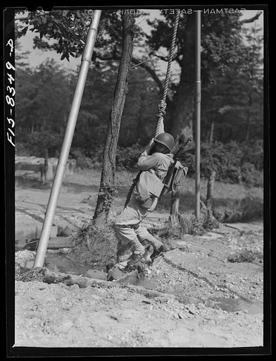 Untitled photo, possibly related to: Fort Belvoir, Virginia. Sergeant George Camblair getting rigorous physical training on the obstacle course