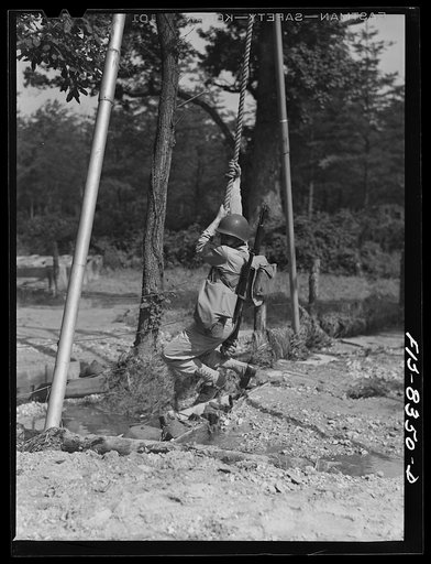 Untitled photo, possibly related to: Fort Belvoir, Virginia. Sergeant George Camblair getting rigorous physical training on the obstacle course