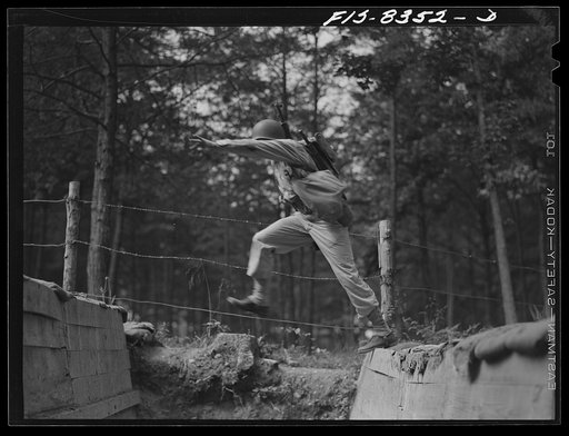 Untitled photo, possibly related to: Fort Belvoir, Virginia. Sergeant George Camblair getting rigorous physical training on the obstacle course