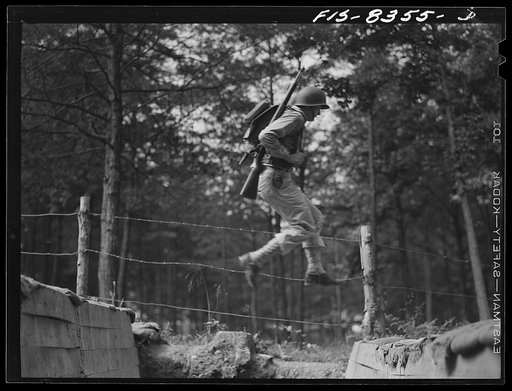 Fort Belvoir, Virginia. Sergeant George Camblair getting rigorous physical training on the obstacle course