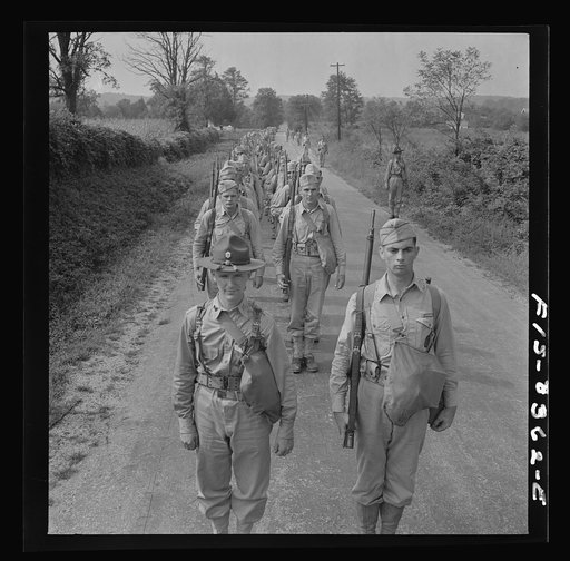Untitled photo, possibly related to: Fort Belvoir, Virginia (vicinity). Sergeant George Camblair on a march along the road near camp