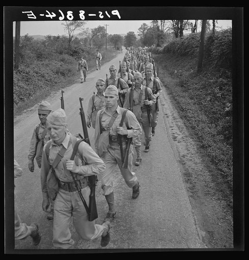 Untitled photo, possibly related to: Fort Belvoir, Virginia (vicinity). Sergeant George Camblair on a march along the road near camp