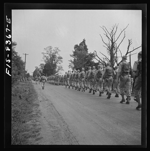 Untitled photo, possibly related to: Fort Belvoir, Virginia (vicinity). Sergeant George Camblair on a march along the road near camp