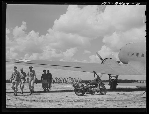 Untitled photo, possibly related to: Fort Bragg, North Carolina. Airborne motorcyclists leaving a transport plane in a military demonstration