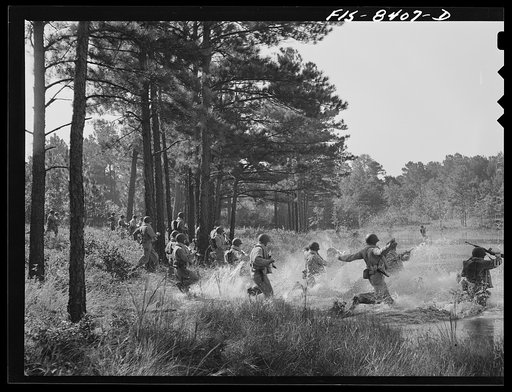 Fort Bragg, North Carolina. Parachutists crossing a stream in a military demonstration