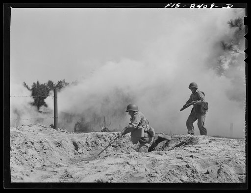 Untitled photo, possibly related to: Fort Bragg, North Carolina. Sergeant Williams leading a machine gun squad in a maneuver