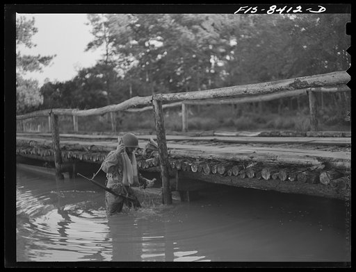 Fort Bragg, North Carolina. Parachutist dynamiting a bridge in a military demonstration