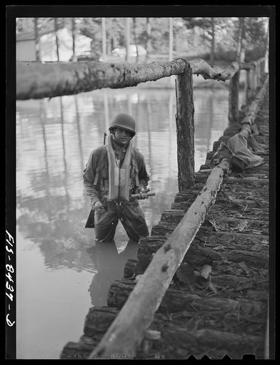 Untitled photo, possibly related to: Fort Bragg, North Carolina. Parachutist dynamiting a bridge in a military demonstration