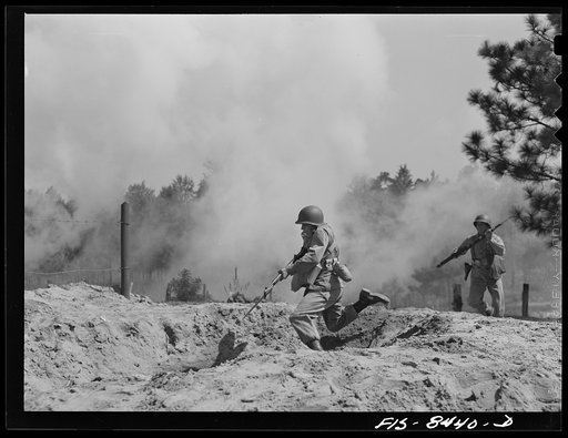 Untitled photo, possibly related to: Fort Bragg, North Carolina. Parachutists leaping into a trench in a military demonstration