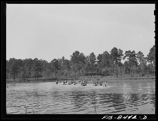 Untitled photo, possibly related to: Fort Bragg, North Carolina. Parachutists crossing a stream in a military demonstration