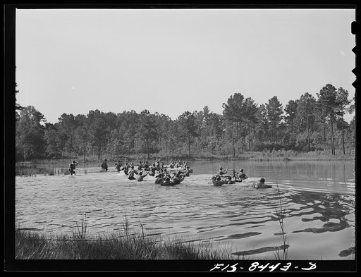 Fort Bragg, North Carolina. Parachutists crossing a stream in a military demonstration