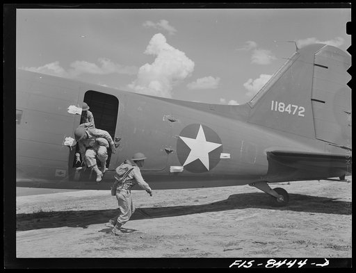 Untitled photo, possibly related to: Fort Bragg, North Carolina. Airborne infantry landing from a transport plane in a military demonstration