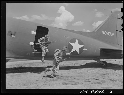 Fort Bragg, North Carolina. Airborne infantry landing from a transport plane in a military demonstration