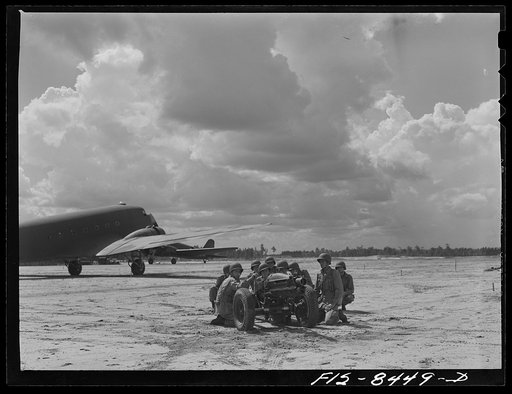 Fort Bragg, North Carolina. Airborne artillery firing a howitzer after landing in a military demonstration
