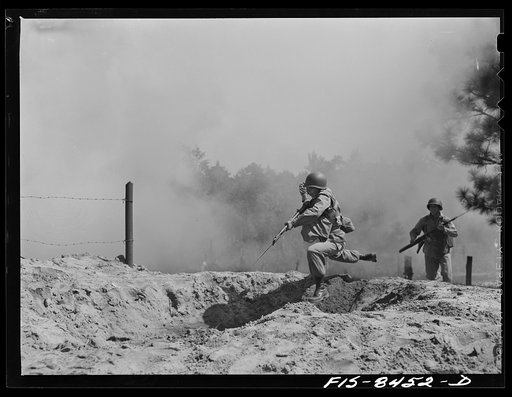 Fort Bragg, North Carolina. Parachutists leaping into a trench in a military demonstration