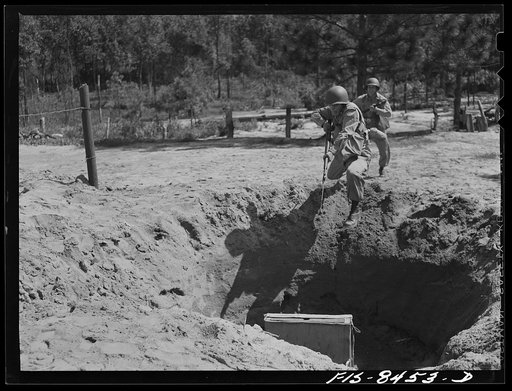 Untitled photo, possibly related to: Fort Bragg, North Carolina. Parachutists leaping into a trench in a military demonstration