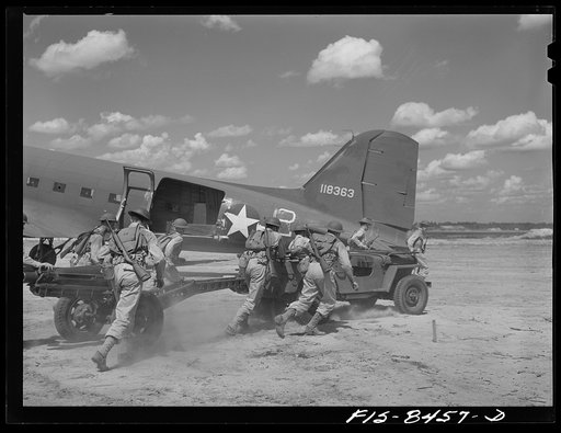 Fort Bragg, North Carolina. Airborne jeep and howitzer going into action after landing in a military demonstration