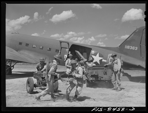 Fort Bragg, North Carolina. Airborne jeep and howitzer going into action after landing in a military demonstration