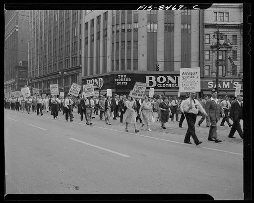 Detroit, Michigan. Men and women workers of the Ford local of the Congress of Industrial Organizations (CIO) carrying banners