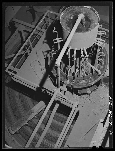 Anaconda smelter, Montana. Anaconda Copper Mining Company. Top of the multiple-hearth roasting furnaces; in these furnaces the ore is moved by gravity from one hearth to the one immediately below it; the flow of ore is such that it goes from the outside of the cylindrical furnaces to the inside on o