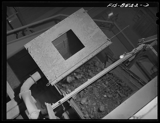 Anaconda smelter, Montana. Anaconda Copper Mining Company. Copper ore going through the Symons crusher; this is an intermediate step between the gyratory crusher and the ore bins