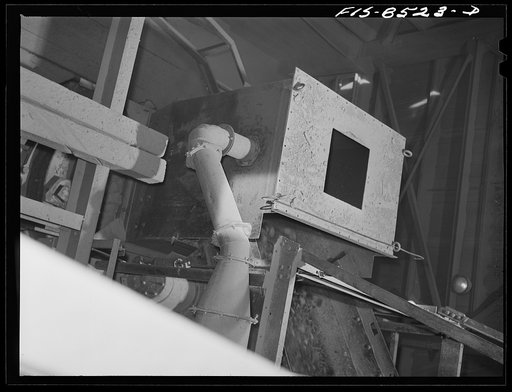 Untitled photo, possibly related to: Anaconda smelter, Montana. Anaconda Copper Mining Company. Copper ore going through the Symons crusher; this is an intermediate step between the gyratory crusher and the ore bins