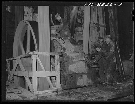 Anaconda smelter, Montana. Anaconda Copper Mining Company. Repairing roll crusher; in this crusher ore is reduced in size from a maximum of one inch to the fineness of coarse sand