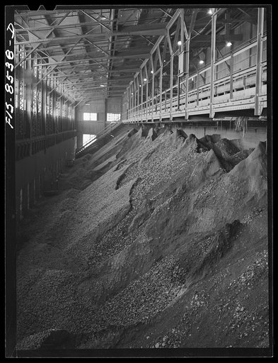 Untitled photo, possibly related to: Anaconda smelter, Montana. Anaconda Copper Mining Company. Crushed copper ore bin; ore from this bin is mixed with water and passed through a series of rollcrushers where the ore is reduced to the fineness of coarse sand