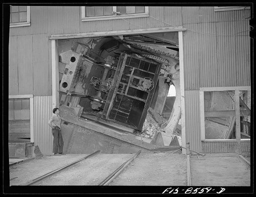 Anaconda smelter, Montana. Anaconda Copper Mining Company. Cars containing fifty tons of copper ore are dumped by an unloading mechanism into a 200 ton hopper