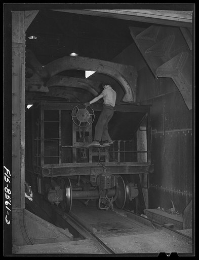 Anaconda smelter, Montana. Anaconda Copper Mining Company. Brakeman setting the brakes on an ore car in the unloading mechanism which will dump the ore into a 200 ton hopper
