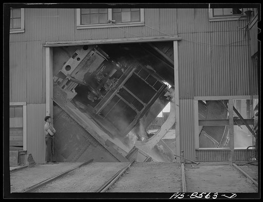 Untitled photo, possibly related to: Anaconda smelter, Montana. Anaconda Copper Mining Company. Cars containing fifty tons of copper ore are dumped by an unloading mechanism into a 200 ton hopper