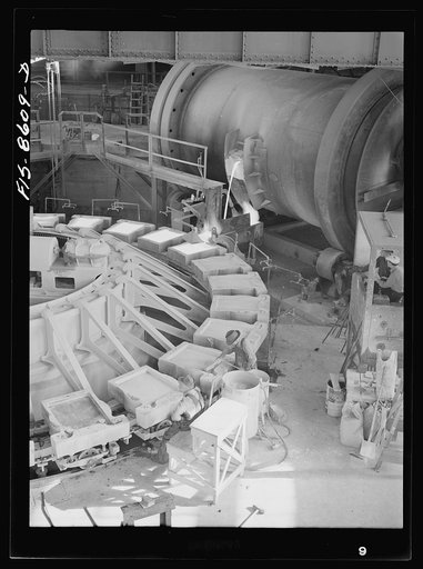 Anaconda smelter, Montana. Anaconda Copper Mining Company. Pouring copper anodes from the refining furnace; forms are previously coated with bone-ash so that the copper anode can be more easily removed after cooling