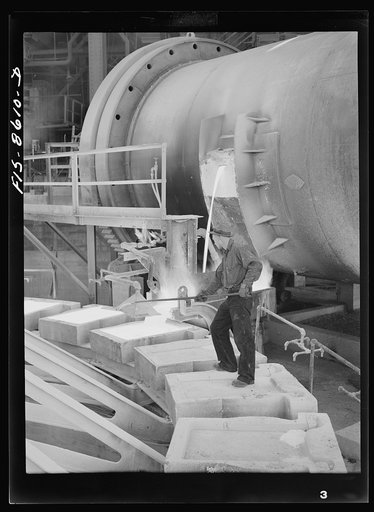 Untitled photo, possibly related to: Anaconda smelter, Montana. Anaconda Copper Mining Company. Pouring copper anodes from the refining furnace; forms are previously coated with bone-ash so that the copper anode can be more easily removed after cooling