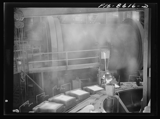 Untitled photo, possibly related to: Anaconda smelter, Montana. Anaconda Copper Mining Company. Pouring copper anodes from the refining furnace; product at this stage is about ninety-nine and one quarter percent copper