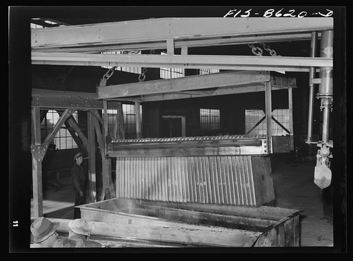 Anaconda smelter, Montana. Anaconda Copper Mining Company. Finished and cooled copper anodes are carried by crane to a convenient stacking place; each anode weighs approximately 740 pounds