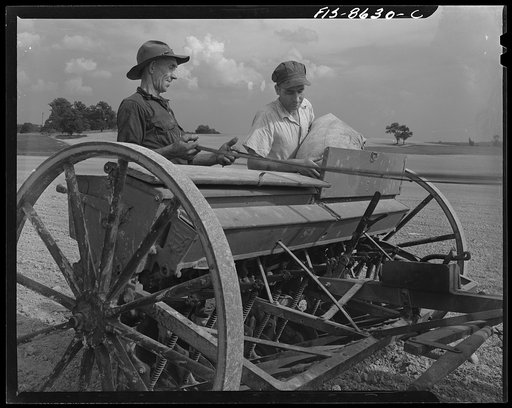 Beltsville, Maryland. Employees of the United States Department of Agriculture experimental farm demonstrating the care and repair of farm machinery for posters to be used in a "Share and Repair" conservation program