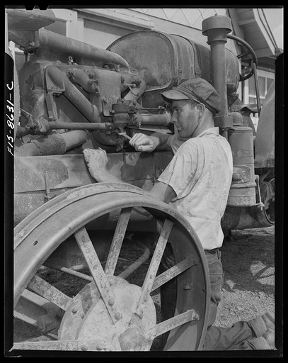 Untitled photo, possibly related to: Beltsville, Maryland. Employees of the United States Department of Agriculture experimental farm demonstrating the care and repair of farm machinery for posters to be used in a "Share and Repair" conservation program